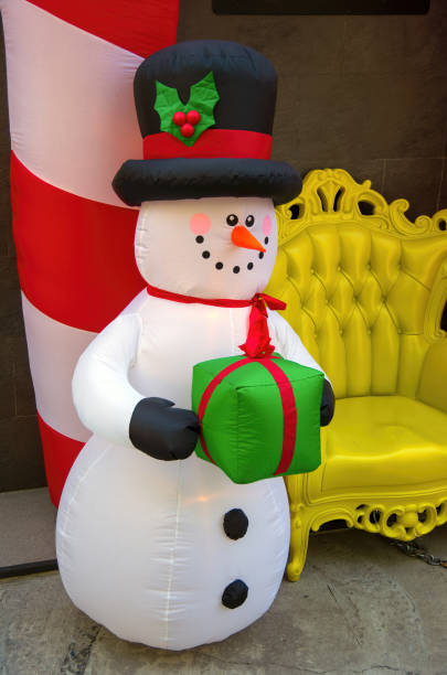Inflatable snowman figure next to an outdoor Christmas photo booth