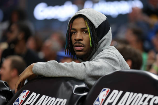 Injured Ja Morant of the Memphis Grizzlies sits on the bench during the first half of Game Four of the Western Conference Semifinals tate Warriors of...