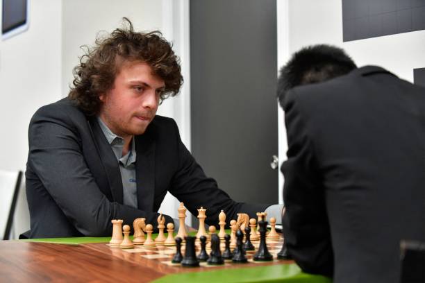 International grandmaster Hans Niemann waits his turn to move during a second-round chess game against Jeffery Xiong on the second day of the Saint...