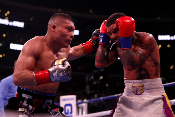Isaac Cruz punches Gervonta Davis during their WBA World Lightweight Championship title bout at Staples Center on December 05, 2021 in Los Angeles,...