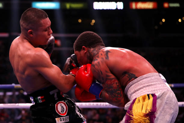 Isaac Cruz punches Gervonta Davis during their WBA World Lightweight Championship title bout at Staples Center on December 05, 2021 in Los Angeles,...