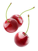 Isolated cherries flying in the air