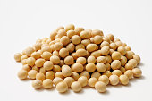Isolated shot of stacked dried soybeans on white background