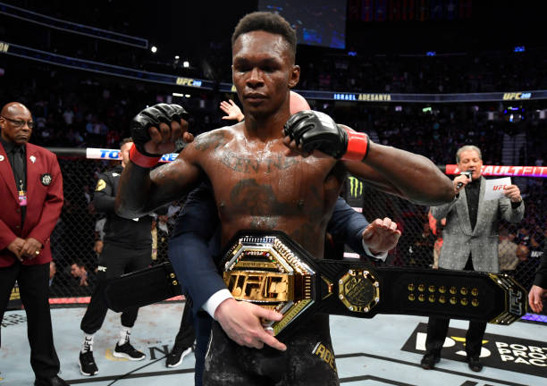 Israel Adesanya of Nigeria celebrates after defeating Yoel Romero of Cuba in their UFC middleweight championship fight during the UFC 248 event at...