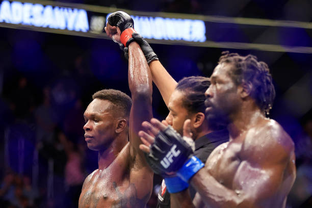 Israel Adesanya of Nigeria celebrates his unanimous decision win over Jared Cannonier in their middleweight title bout during UFC 276 at T-Mobile...