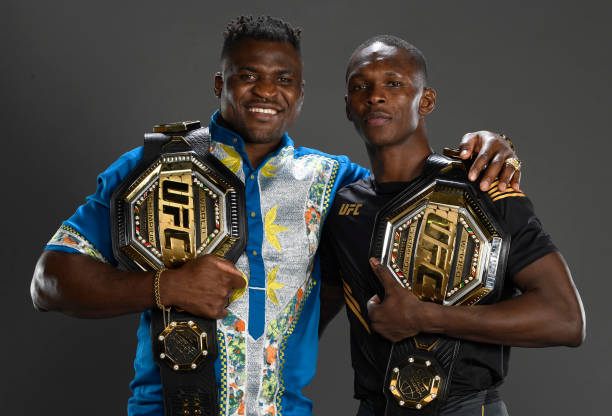 Israel Adesanya of Nigeria poses for a portrait with UFC heavyweight champion Francis Ngannou of Cameroon after his victory during the UFC 263 event...
