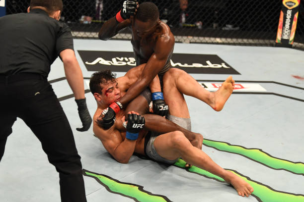 Israel Adesanya of Nigeria punches Paulo Costa of Brazil in their middleweight championship bout during UFC 253 inside Flash Forum on UFC Fight...