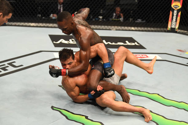 Israel Adesanya of Nigeria punches Paulo Costa of Brazil in their middleweight championship bout during UFC 253 inside Flash Forum on UFC Fight...