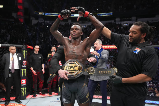 Israel Adesanya of Nigeria reacts after defeating Robert Whittaker of Australia by unanimous decision in their UFC middleweight championship fight...