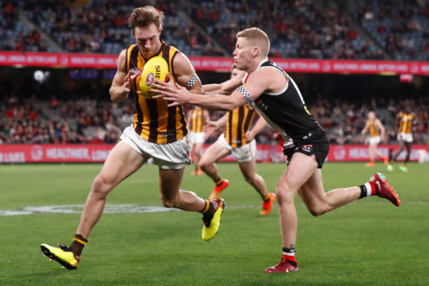 Jack Scrimshaw of the Hawks and Dan Hannebery of the Saints compete during the round 20 AFL match between the St Kilda Saints and the Hawthorn Hawks...