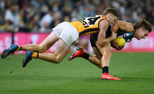 Jackson Mead of Port Adelaide tackled by Denver Grainger-Barras of the Hawks during the round two AFL match between the Port Adelaide Power and the...