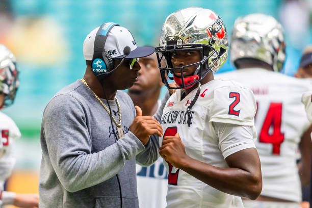 Jackson State Tigers head coach Deion Sanders interacts with Jackson State Tigers quarterback Shedeur Sanders during the Orange Blossom Classic game...