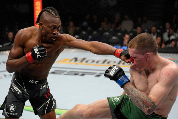 Jalin Turner punches Jamie Mullarkey of Australia in their lightweight fight during the UFC 272 event on March 05, 2022 in Las Vegas, Nevada.