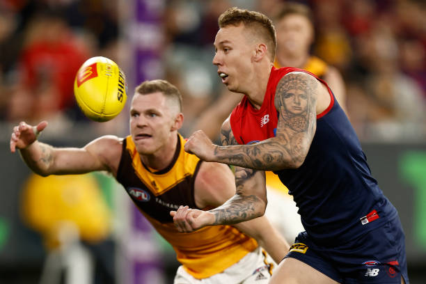 James Harmes of the Demons handballs during the round seven AFL match between the Melbourne Demons and the Hawthorn Hawks at Melbourne Cricket Ground...