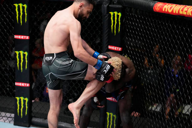 Javid Basharat of England knees Trevin Jones of Guam in their bantamweight fight during the UFC Fight Night event at UFC APEX on March 12, 2022 in...