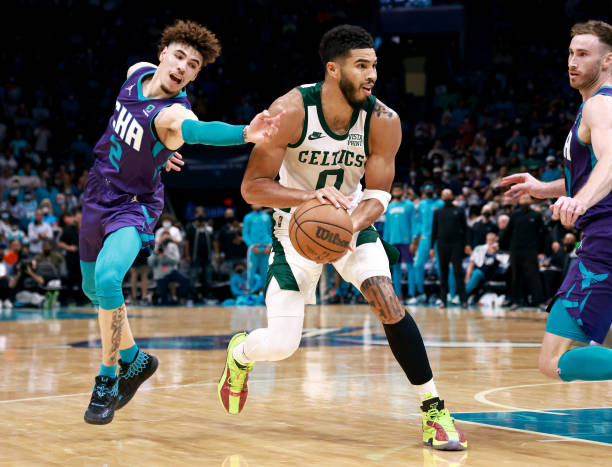 Jayson Tatum of the Boston Celtics drives past LaMelo Ball of the Charlotte Hornets during the second half of their game at Spectrum Center on...
