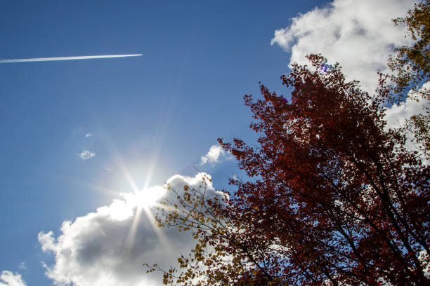 Jet flying through the sky on an Autumn day in Maine USA