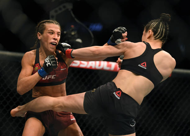 Joanna Jedrzejczyk punches Weili Zhang in a split decision loss during a strawweight title bout at T-Mobile Arena on March 07, 2020 in Las Vegas,...