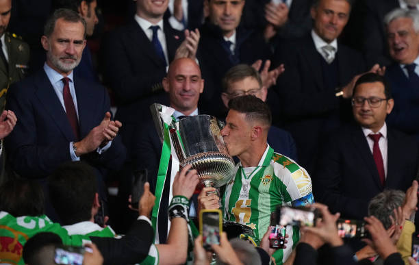Joaquin of Real Betis kisses the Copa del Rey trophy as Felipe VI of Spain looks on after the Copa del Rey final match between Real Betis and...