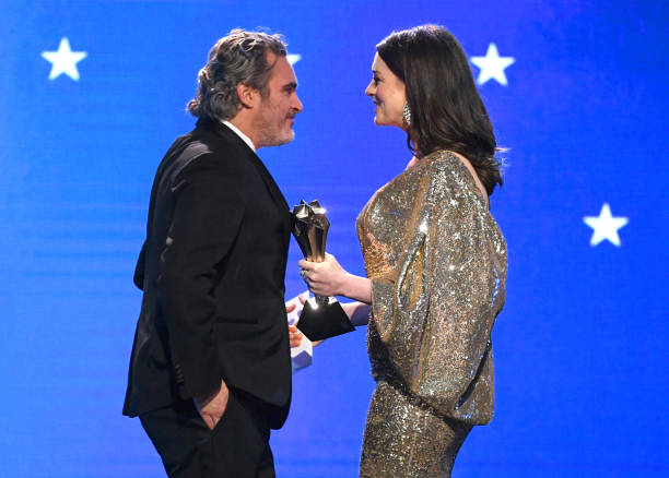 Joaquin Phoenix accepts the Best Actor award for 'Joker' from Anne Hathaway onstage during the 25th Annual Critics' Choice Awards at Barker Hangar on...