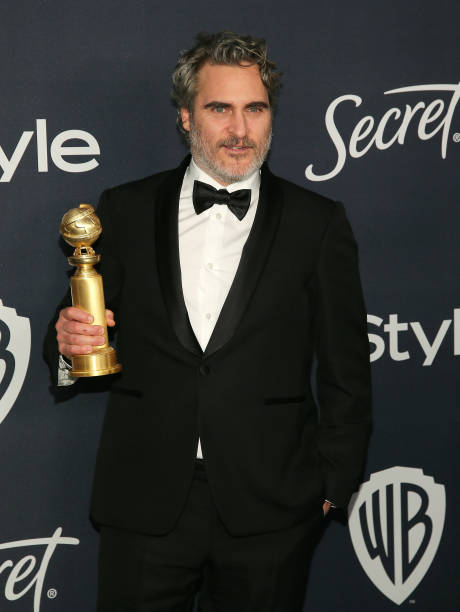 Joaquin Phoenix poses for a photo with his award for Best Performance by an Actor in a Motion Picture Drama at the 21st Annual Warner Bros And...