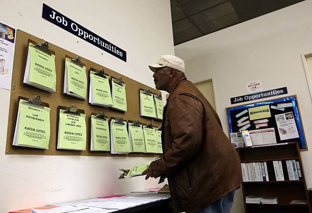 Job Seeker Kenneth Massingale looks at job listings posted at the East Bay Works One-Stop Career Center April 17, 2009 in Oakland, California. The...