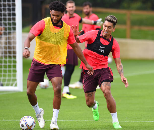 Joe Gomez of Liverpool with Roberto Firmino of Liverpool during a training session at AXA Training Centre on August 04, 2022 in Kirkby, England.