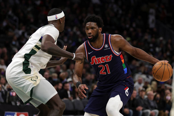 Joel Embiid of the Philadelphia 76ers is defended by Bobby Portis of the Milwaukee Bucks during the second half of a game at Fiserv Forum on February...