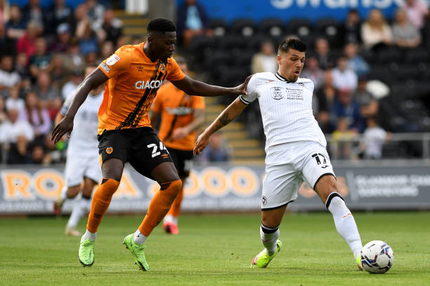 Joël Piroe of Swansea City under pressure from DiShon Bernard of Hull City during the Sky Bet Championship match between Swansea City and Hull City...