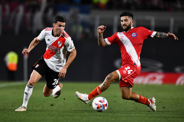 Jose Paradela of River Plate fights for the ball with Elias Gomez of Argentinos Juniors during a match between River Plate and Argentinos Juniors as...