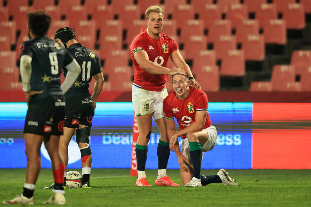 JOHANNESBURG, SOUTH AFRICA - JULY 07: Josh Adams (R) of The British and Irish Lions celebrates with teammate Duhan van der Merwe after scoring their side's fifth try during the Cell C Sharks v British & Irish Lions tour match at Emirates Airline Park on July 07, 2021 in Johannesburg, South Africa. (Photo by David Rogers/Getty Images)