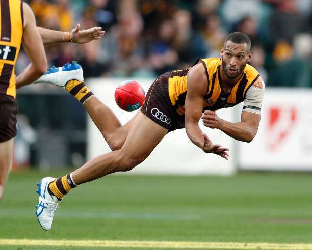 Josh Gibson of the Hawks handpasses the ball during the 2017 AFL round 08 match between the Hawthorn Hawks and the Brisbane Lions at the University...
