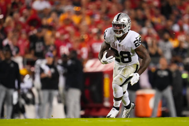 Josh Jacobs of the Las Vegas Raiders runs the ball against the Kansas City Chiefs at GEHA Field at Arrowhead Stadium on October 10, 2022 in Kansas...