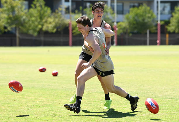 Josh Ward and Connor MacDonald of the Hawks battle for the ball during a Hawthorn Hawks AFL training session at Bunjil Bagora on November 29, 2021 in...