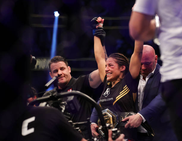 Julianna Pena celebrates after defeating Amanda Nunes of Brazil to win the women's bantamweight title during the UFC 269 event at T-Mobile Arena on...