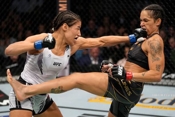 Julianna Pena punches Amanda Nunes of Brazil in their UFC bantamweight championship bout during the UFC 269 on December 11, 2021 in Las Vegas, Nevada.
