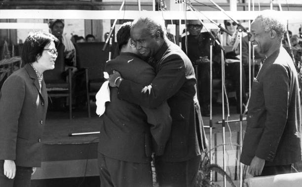 President Nyerere watches as President Kenneth Kaunda of Zambia greets the Chinese VicePremier Sun Chien at the handing over ceremony of the Tanzania...