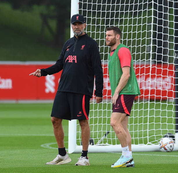 Jurgen Klopp manager of Liverpool with James Milner of Liverpool during a training session at AXA Training Centre on August 04, 2022 in Kirkby,...