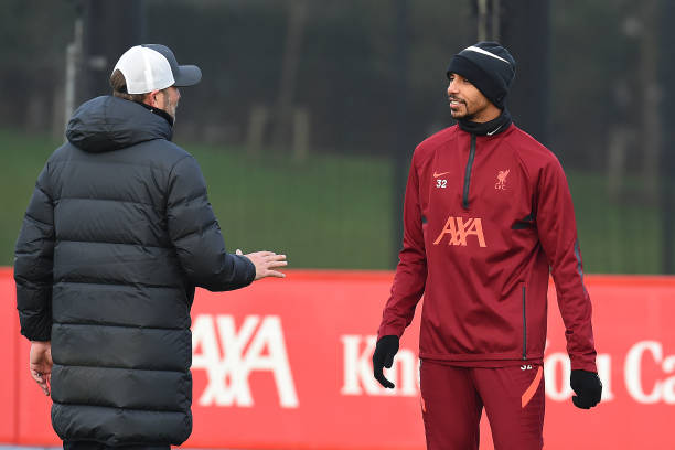 Jurgen Klopp manager of Liverpool with Joel Matip of Liverpool during a training session at AXA Training Centre on December 24, 2021 in Kirkby,...