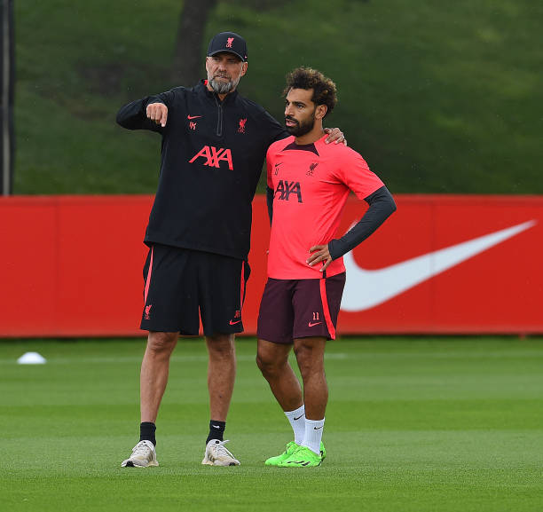 Jurgen Klopp manager of Liverpool with Mohamed Salah of Liverpool during a training session at AXA Training Centre on August 04, 2022 in Kirkby,...