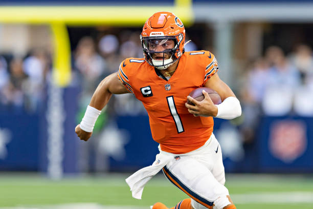 Justin Fields of the Chicago Bears runs the ball during a game against the Dallas Cowboys at AT&T Stadium on October 30, 2022 in Arlington, Texas....