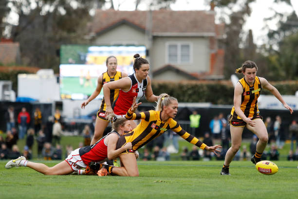 Kaitlyn Ashmore of the Hawks is tackled by Hannah Stuart of the Saints during the 2022 S7 AFLW Round 02 match between the Hawthorn Hawks and the St...