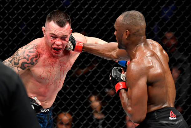 Kamaru Usman of Nigeria punches Colby Covington in their UFC welterweight championship bout during the UFC 245 event at T-Mobile Arena on December...