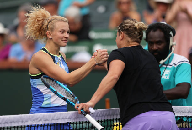 Katerina Siniakova of the Czech Republic shakes hands at the net after her three set victory against Kim Clijsters of Belgium during their first...