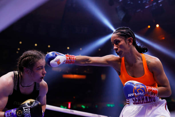 Katie Taylor of Ireland trades punches with Amanda Serrano of Puerto Rico for the World Lightweight Title fight at Madison Square Garden on April 30,...