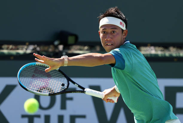 Kei Nishikori of Japan plays a forehand against Dan Evans of Great Britain during their second round match on Day 6 of the BNP Paribas Open at the...