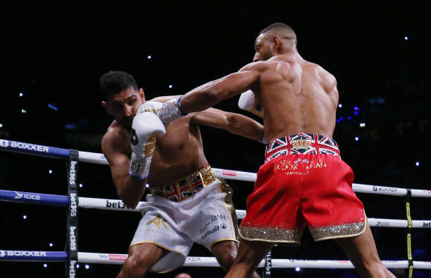 Kell Brook punches Amir Khan during their Welterweight contest at AO Arena on February 19, 2022 in Manchester, England.
