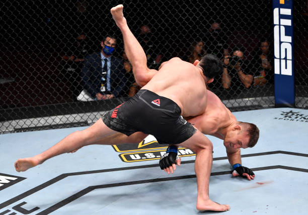 Kelvin Gastelum takes down Ian Heinisch in their middleweight fight during the UFC 258 event at UFC APEX on February 13, 2021 in Las Vegas, Nevada.