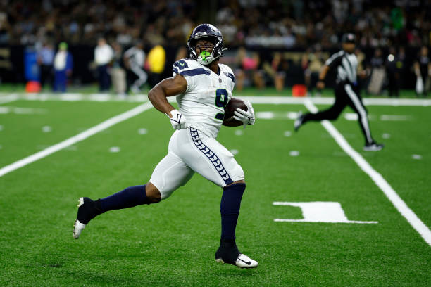 Kenneth Walker III of the Seattle Seahawks looks back as he runs for a touchdown against the New Orleans Saints at Caesars Superdome on October 09,...