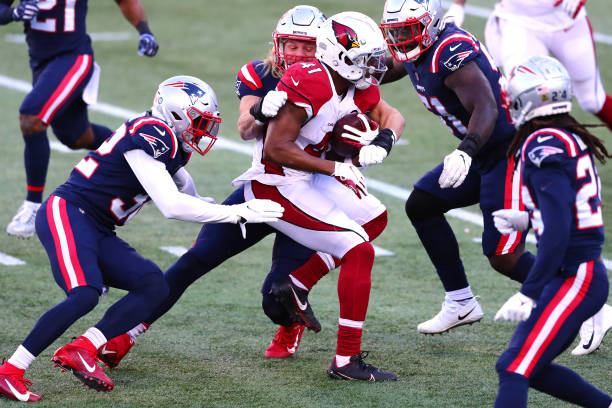 Kenyan Drake of the Arizona Cardinals runs with the ball against the New England Patriots during the first half of the game at Gillette Stadium on...